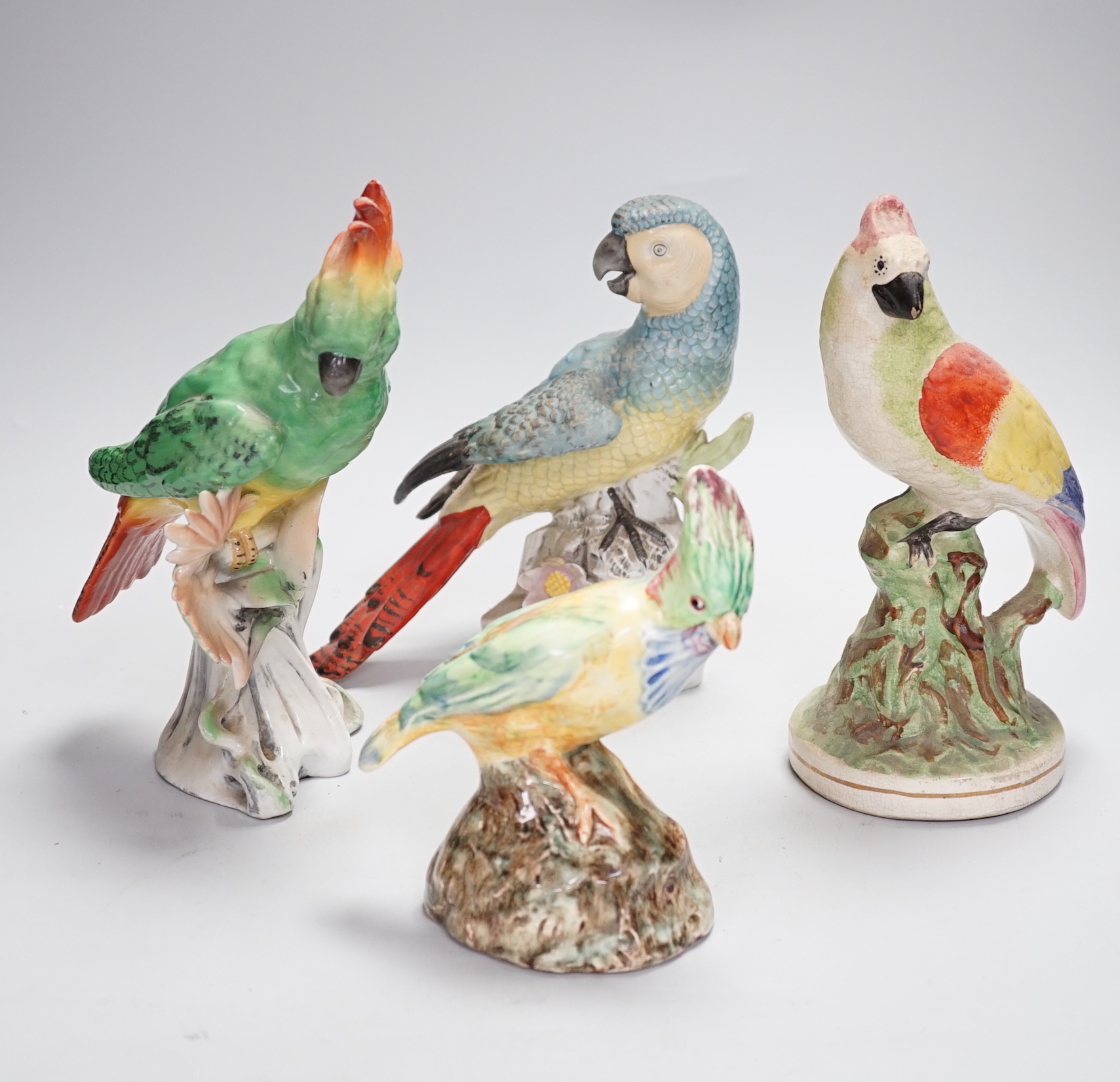 A group of twelve ceramic parrots including one by S Hancock & Sons, largest 24cm high